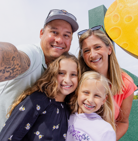 A happy family in front of the I love GB sign.