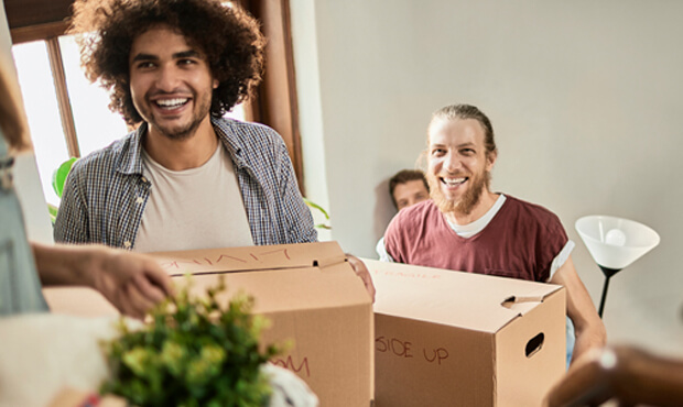 First time home buyer, bringing boxes inside their new home. 