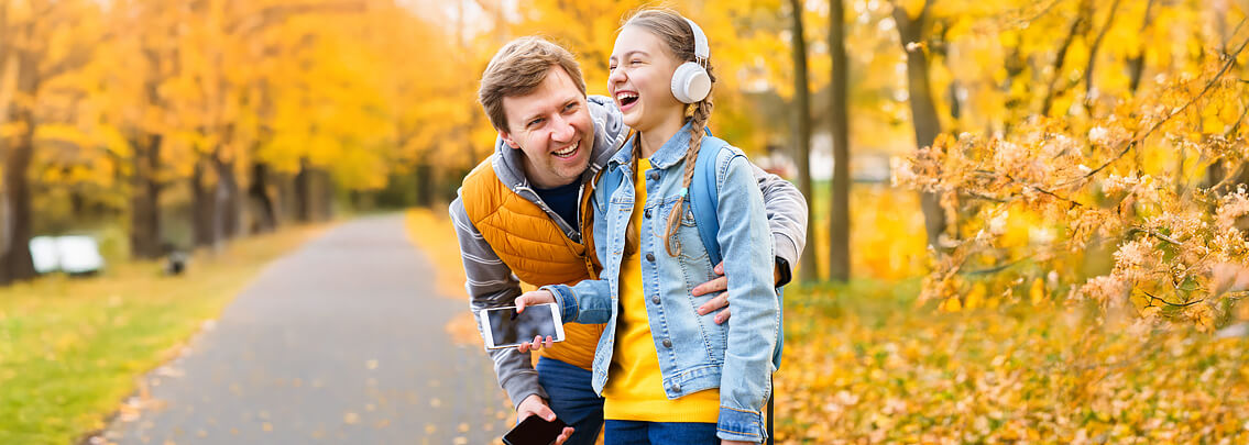 Father and daughter outside enjoying fall weather. 