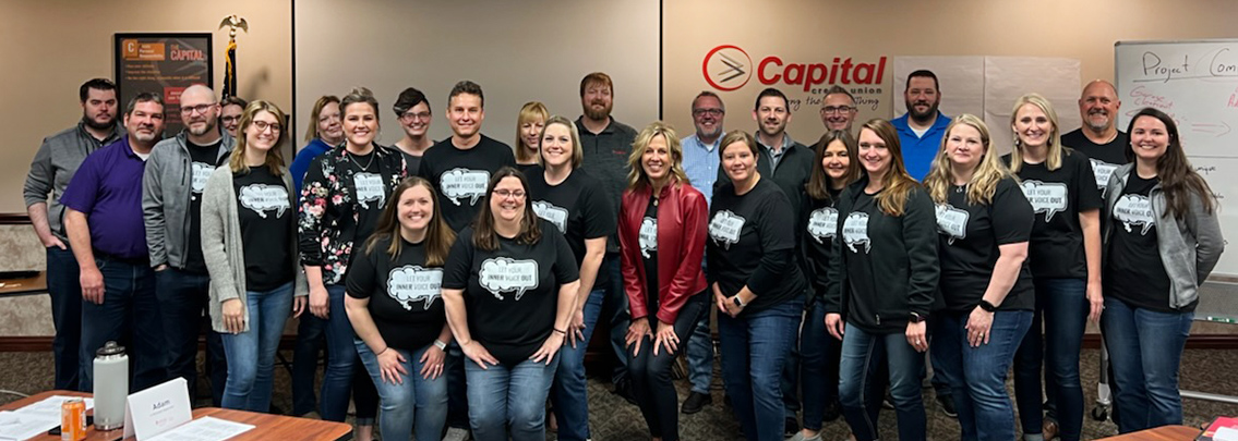 Capital Credit Union staff gathered together wearing t-shirts promoting mental health awareness