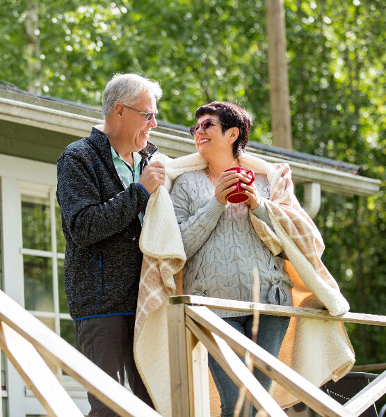 Elder couple outside of vacation home.