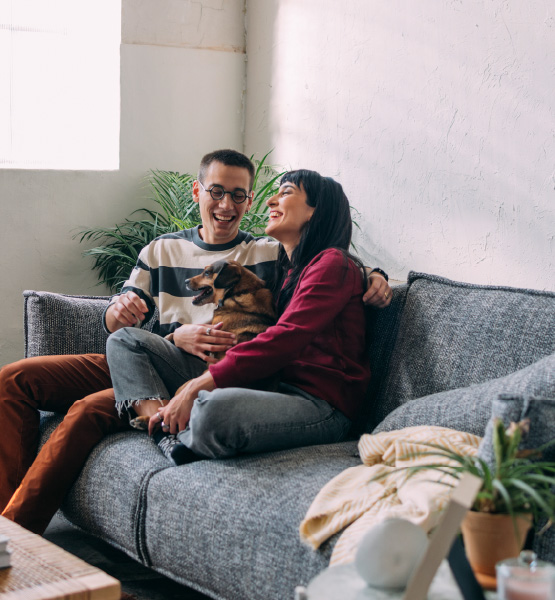 couple sitting on with dog