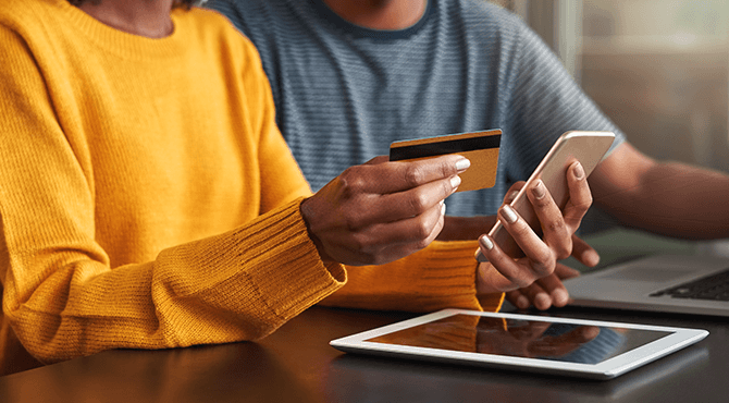 couple, lady holding her phone and credit card.