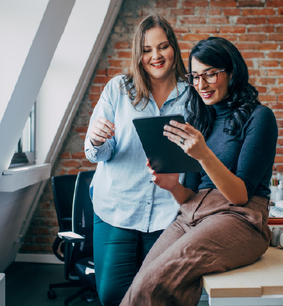 business women working together on a tablet