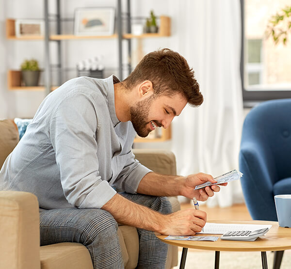 Man calculating monthly expenses for
debt consolidation using a home equity loan