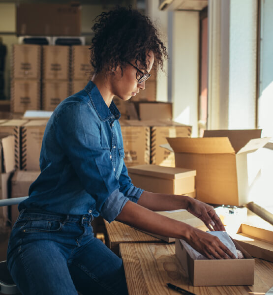 Business woman packaging items.