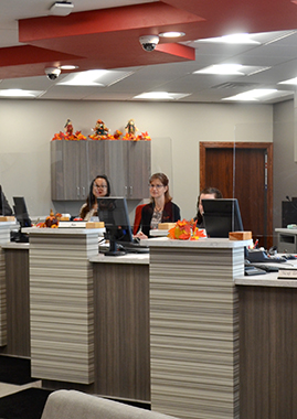 Capital Credit Union staff stationed behind the teller line awaiting members to come into the branch