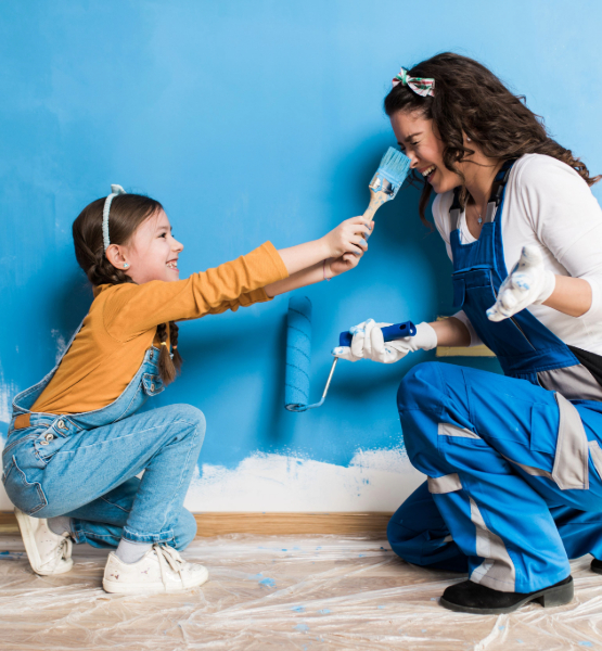 Child brushing paint on her moms nose. 