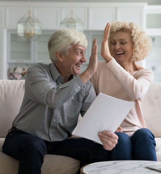 Elder couple high fiving eachother.