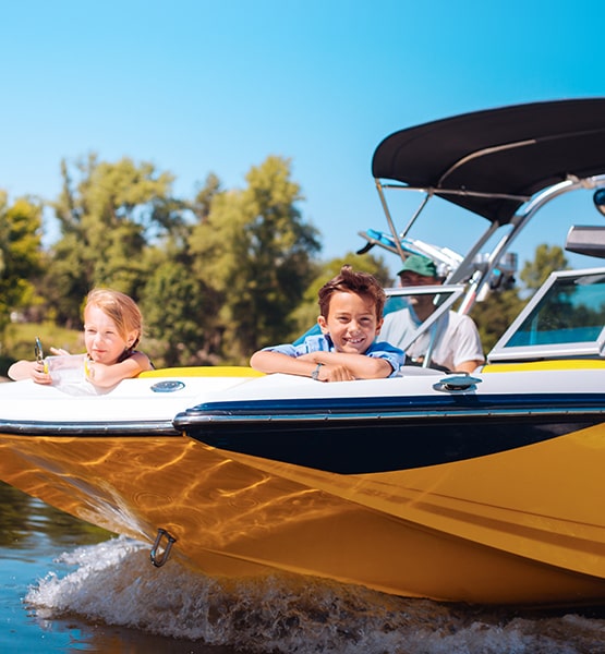 boy, girl and dad in a boat.