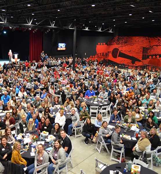 Capital Credit Union staff gathered at tables for an all staff meeting at the Epic Event Center