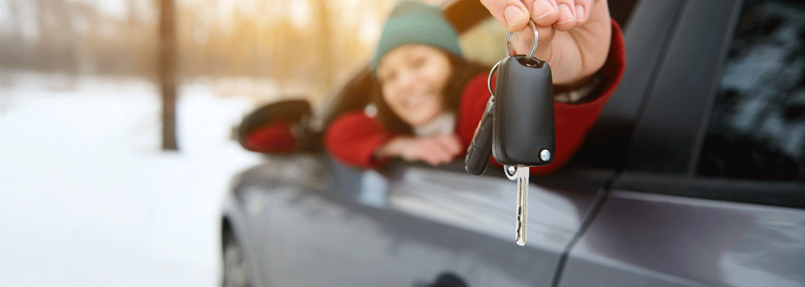 Lady holding key to new car