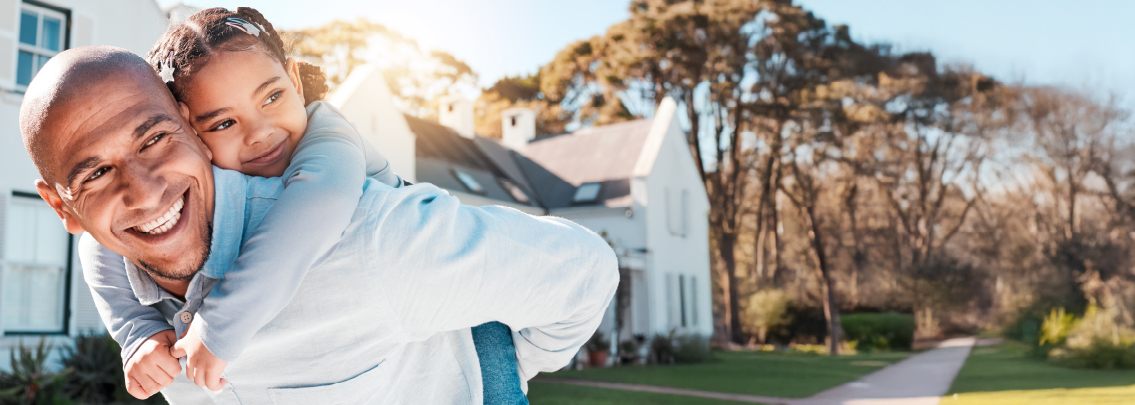 Dad giving daughter a piggyback ride.