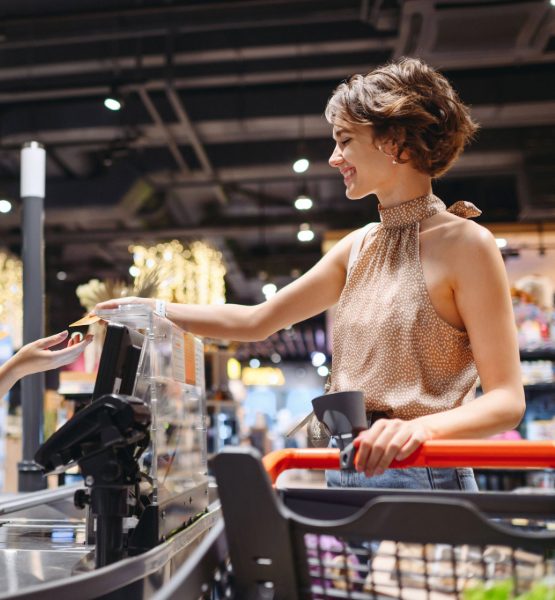 Woman using debit card to shop.