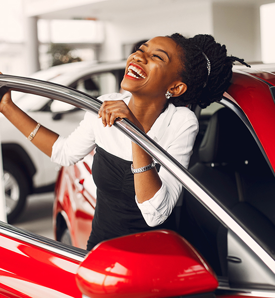 Lady smiling in new car.