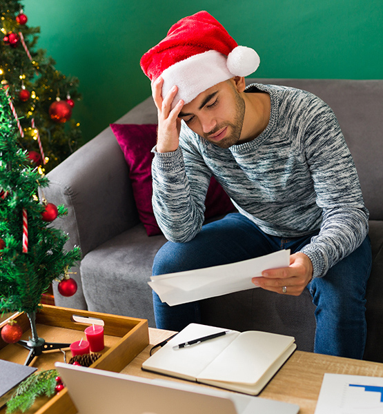 stressed man in santa hat