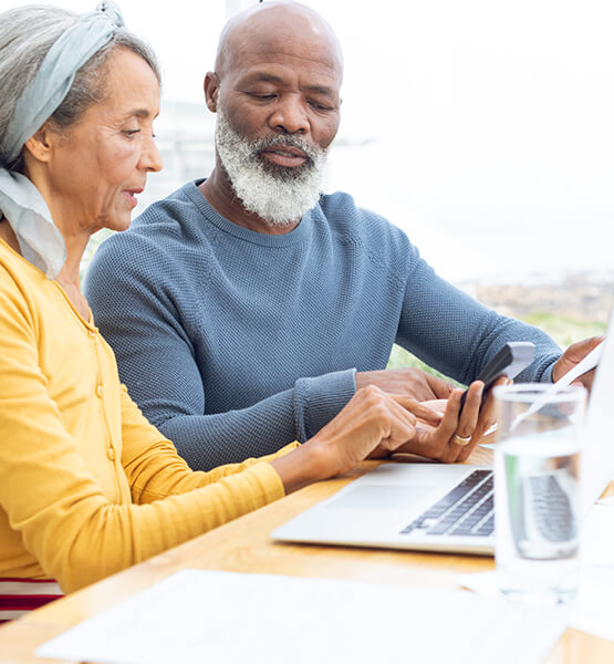 Couple looking at financial options on their laptop.