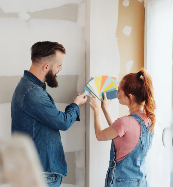 Couple choosing out a color for their walls.