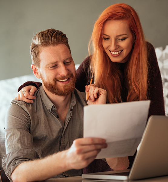 Male and female looking at paper