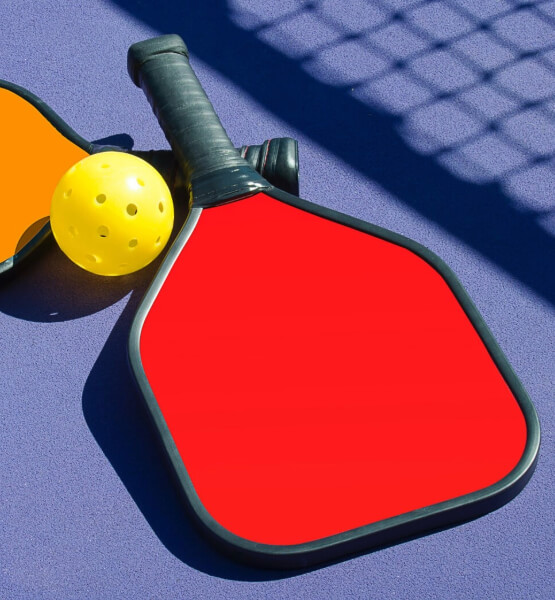 Pickleball paddles and ball. 