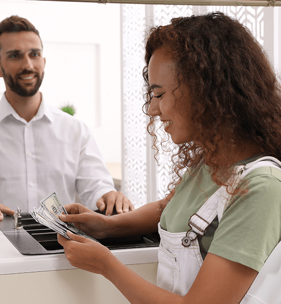 Women counting cash from the register. 