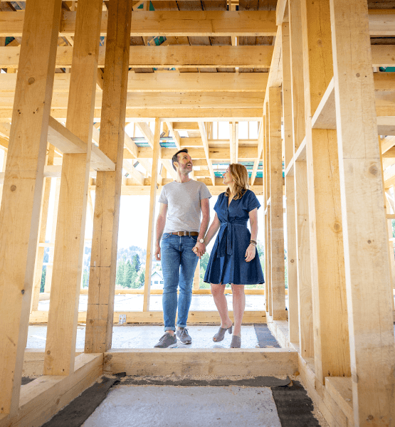 Couple walking in construction built home.