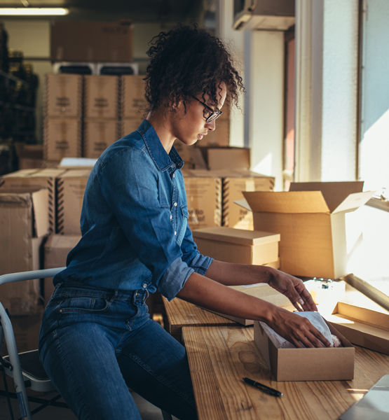 Business women boxing items.