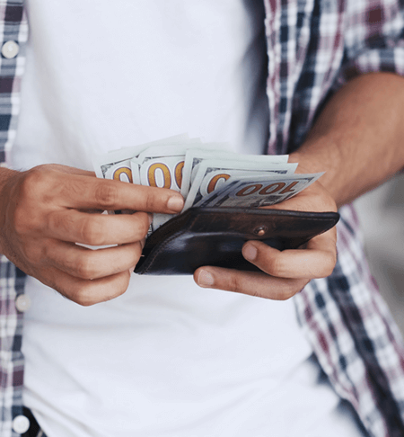 Man in plaid shirt counting money.