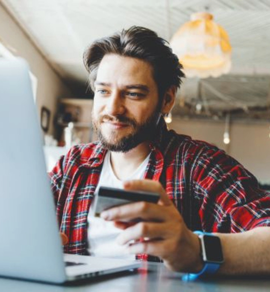 Man using a laptop and looking at checknig options.