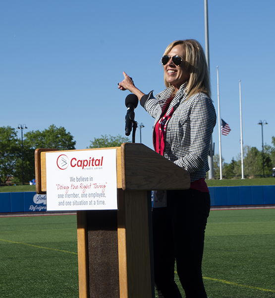Capital Credit Union president / CEO Laurie Butz speaking at a podium at Capital Credit Union Park