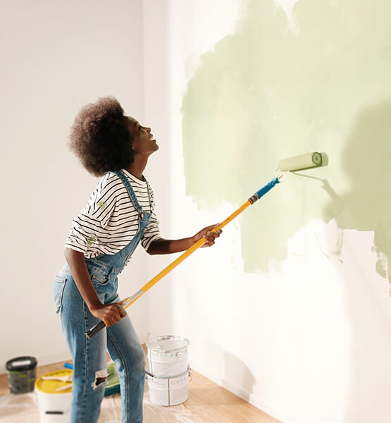 Women painting the walls light green.