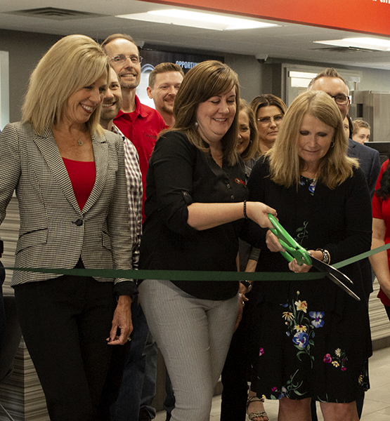 Capital Credit Union staff participating in ribbon cutting presentation at a remodeled branch